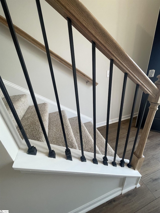 stairway with hardwood / wood-style flooring