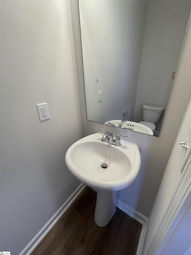 bathroom featuring hardwood / wood-style floors, sink, and toilet