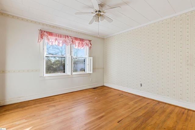 unfurnished room with ceiling fan, crown molding, and wood-type flooring