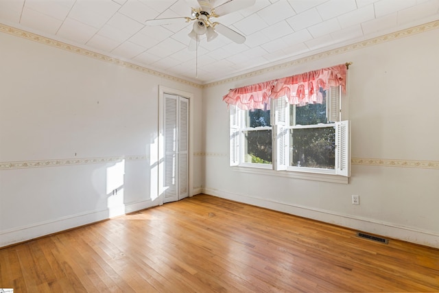 spare room with hardwood / wood-style floors and ceiling fan