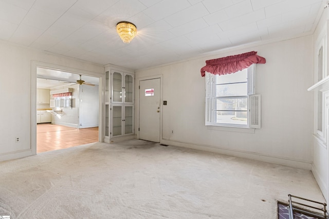 empty room featuring ceiling fan and carpet