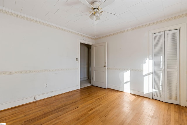 unfurnished bedroom featuring ceiling fan and hardwood / wood-style flooring