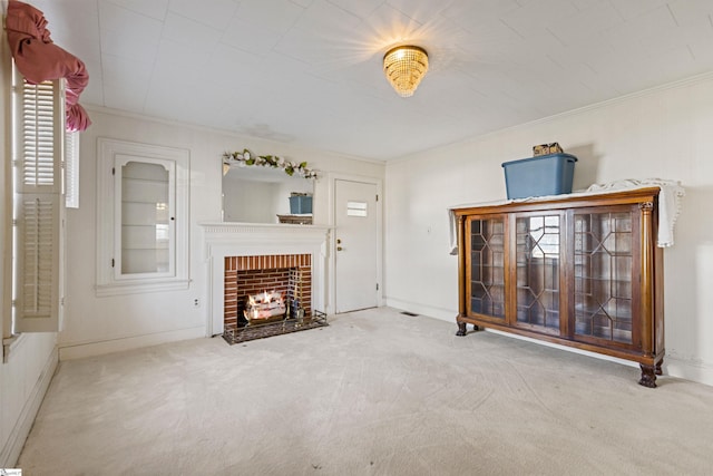 carpeted living room featuring ornamental molding and a fireplace