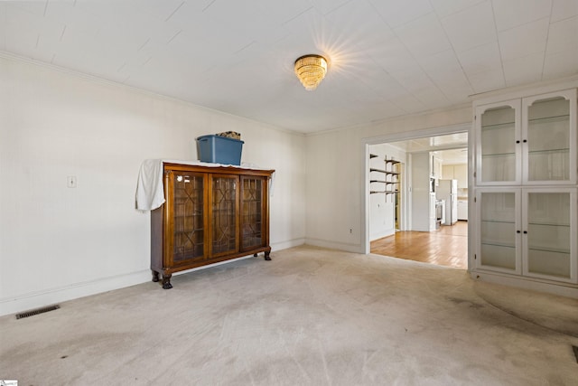 carpeted empty room featuring ornamental molding