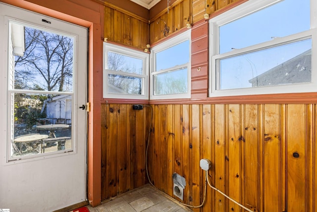 entryway with wooden walls