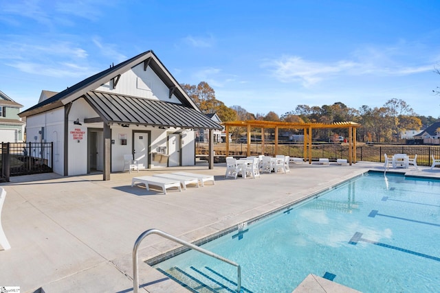 view of swimming pool with a patio and an outdoor structure