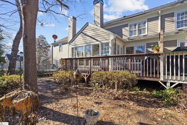 rear view of property featuring a deck