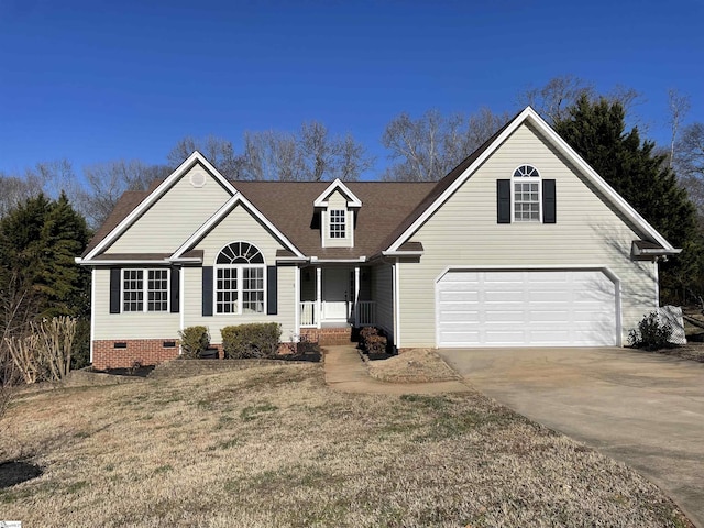 view of front of home featuring covered porch, a garage, and a front yard