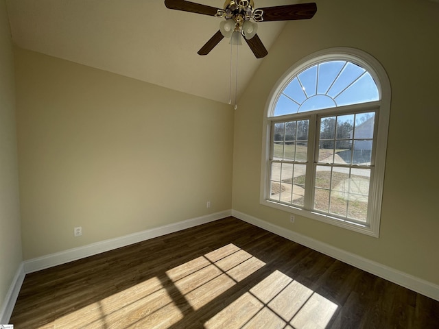 spare room with ceiling fan, lofted ceiling, and dark wood-type flooring