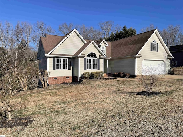 view of front of house featuring a garage and a front lawn