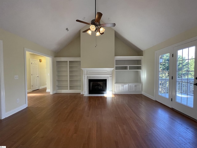 unfurnished living room featuring built in shelves, ceiling fan, dark wood-type flooring, and lofted ceiling