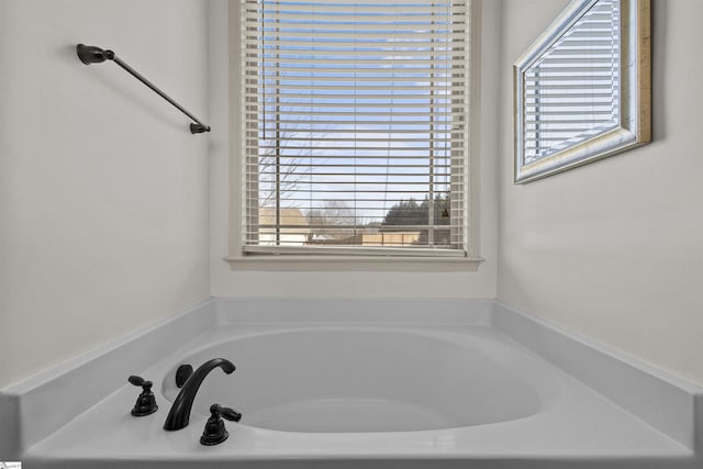 bathroom with plenty of natural light and a washtub