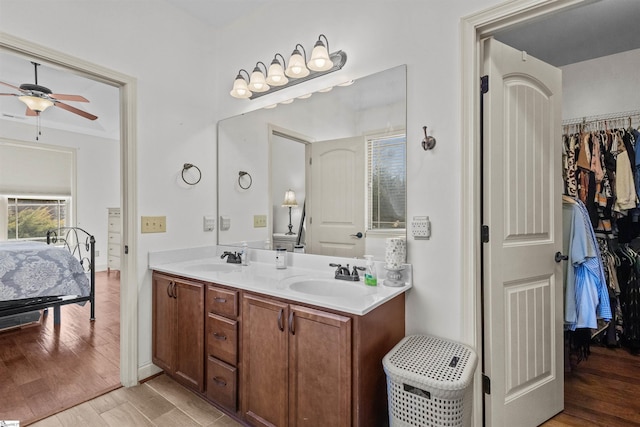 bathroom featuring hardwood / wood-style floors, vanity, and ceiling fan