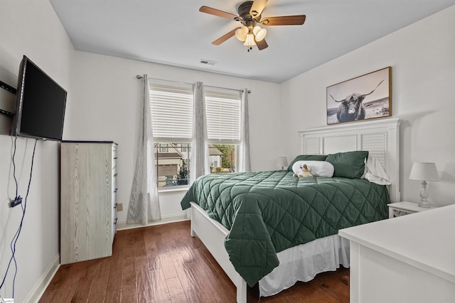 bedroom featuring ceiling fan and dark wood-type flooring