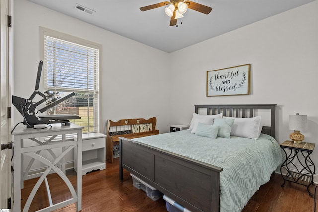 bedroom with multiple windows, ceiling fan, and dark hardwood / wood-style floors