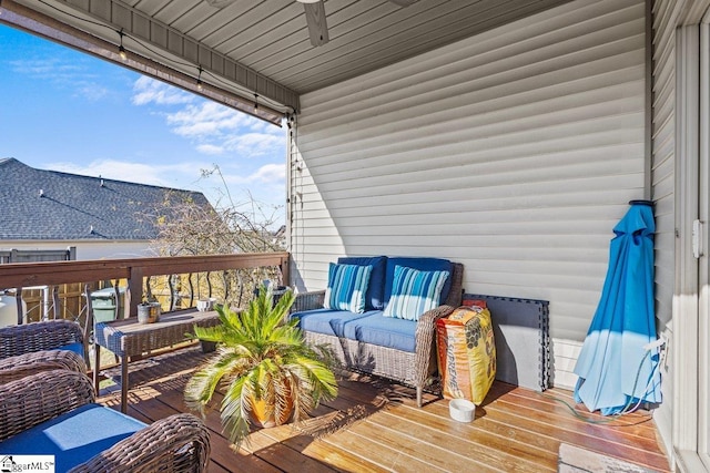 deck featuring ceiling fan and an outdoor living space