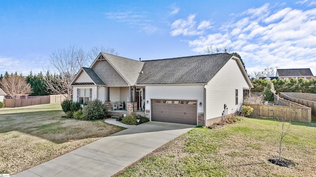 craftsman inspired home featuring a garage and a front lawn