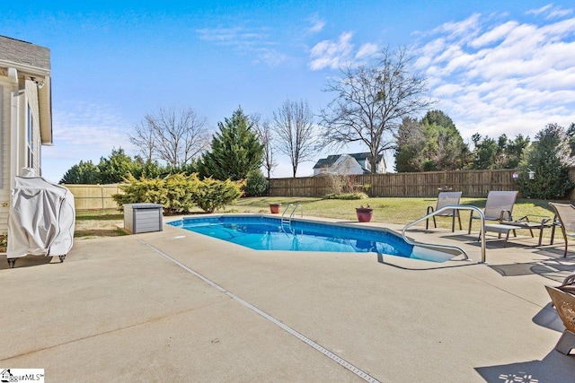 view of pool featuring a lawn and a patio