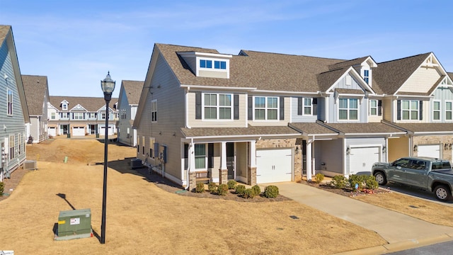 view of front of home with central AC unit and a garage