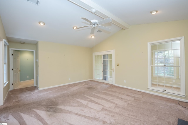 empty room featuring ceiling fan, light colored carpet, and lofted ceiling with beams