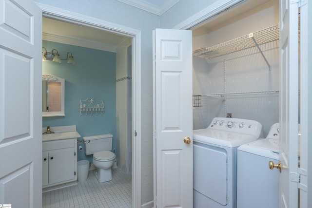 washroom with separate washer and dryer, crown molding, tile patterned flooring, and sink