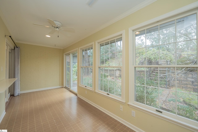 unfurnished sunroom with ceiling fan