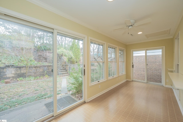 unfurnished sunroom with ceiling fan