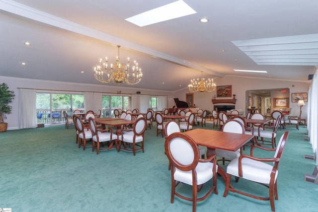 dining area with crown molding, vaulted ceiling with skylight, carpet floors, and a chandelier