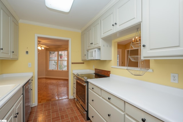 kitchen with white cabinetry, ornamental molding, ceiling fan with notable chandelier, and appliances with stainless steel finishes