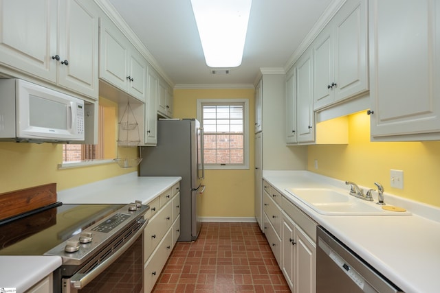 kitchen with sink, white cabinetry, stainless steel appliances, and ornamental molding