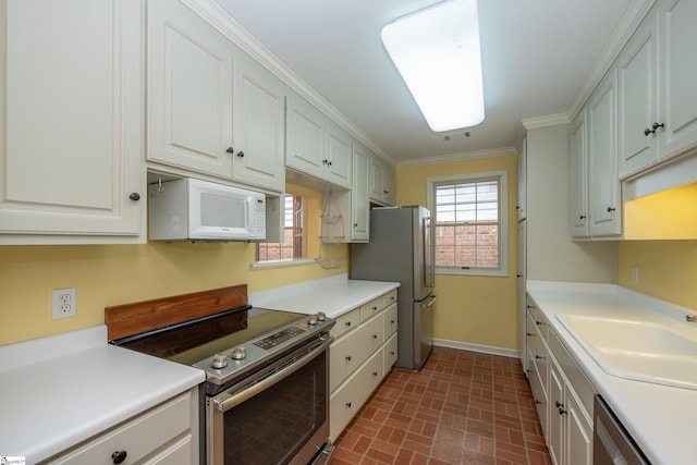 kitchen featuring white cabinetry, crown molding, sink, and appliances with stainless steel finishes