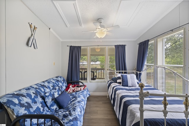 bedroom with ceiling fan, dark hardwood / wood-style floors, a textured ceiling, and multiple windows