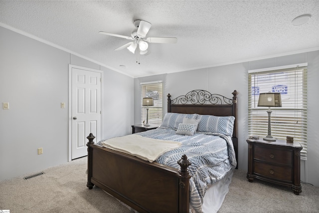 bedroom featuring a textured ceiling, ceiling fan, and light carpet