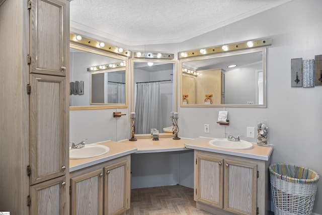 bathroom with vanity, a textured ceiling, vaulted ceiling, and parquet floors