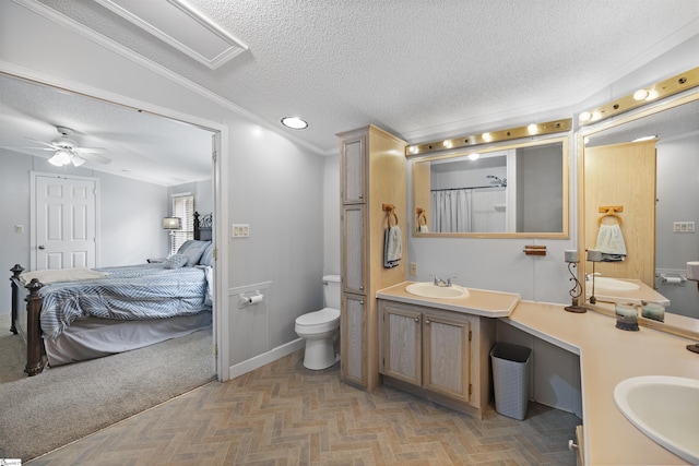 bathroom with lofted ceiling, crown molding, ceiling fan, toilet, and a textured ceiling