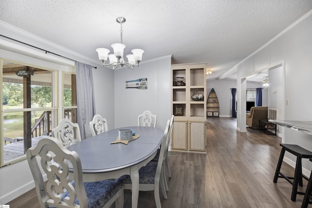 dining space featuring ceiling fan with notable chandelier, a textured ceiling, and ornamental molding