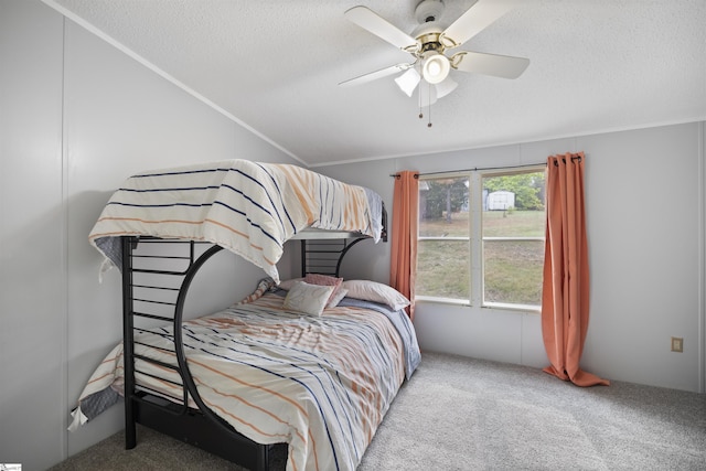 bedroom with carpet, ceiling fan, and a textured ceiling