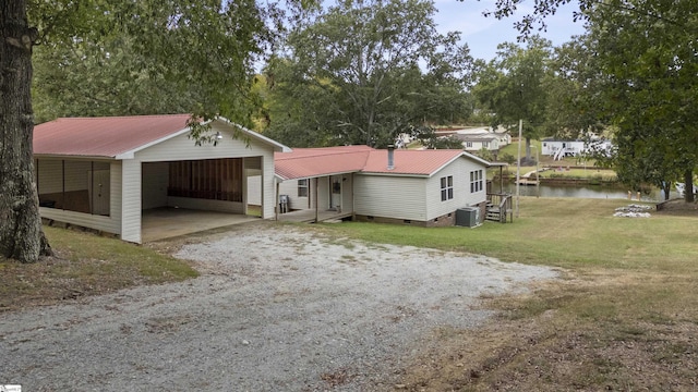 view of front of house featuring a water view, a front yard, and central AC