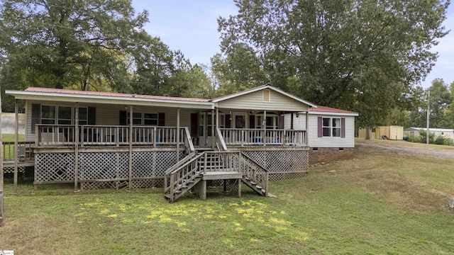 back of house featuring covered porch and a yard