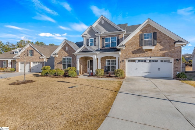 craftsman-style home with a front yard, a porch, and a garage