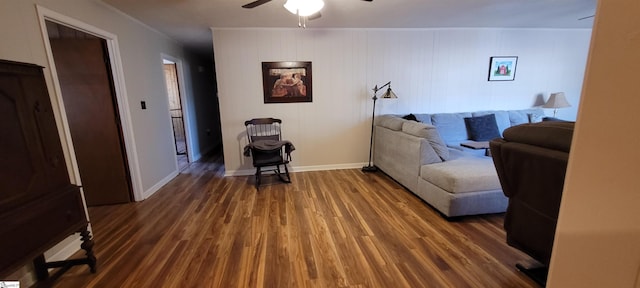 living room featuring ceiling fan, dark hardwood / wood-style flooring, and ornamental molding