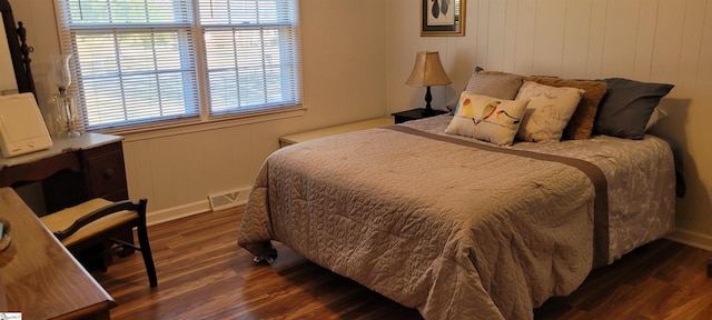 bedroom with dark hardwood / wood-style floors