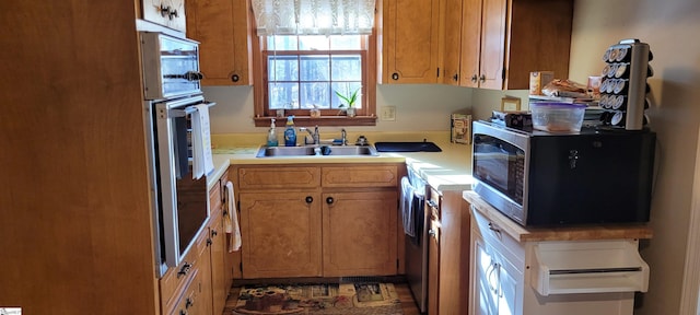 kitchen with wall oven and sink