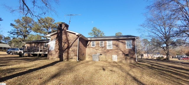 back of house with a yard, central AC unit, and a wooden deck