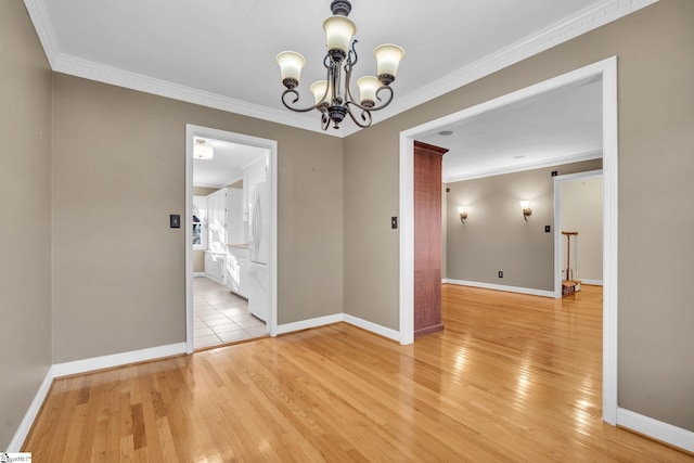 unfurnished dining area with a chandelier, light wood-type flooring, and ornamental molding