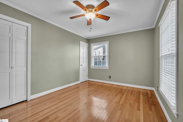 unfurnished bedroom with light hardwood / wood-style flooring, ceiling fan, and crown molding