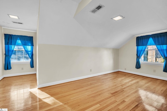 bonus room featuring light hardwood / wood-style floors and vaulted ceiling