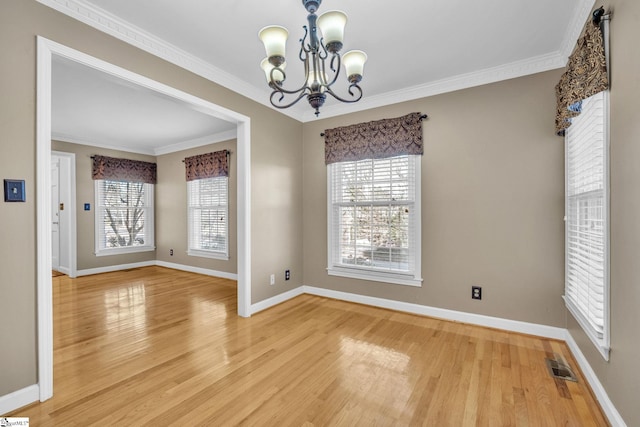 unfurnished dining area featuring a chandelier, hardwood / wood-style floors, and ornamental molding