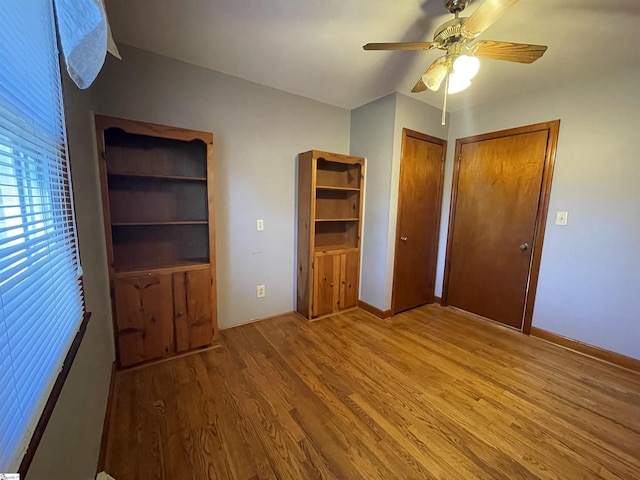 unfurnished bedroom featuring light wood-type flooring and ceiling fan