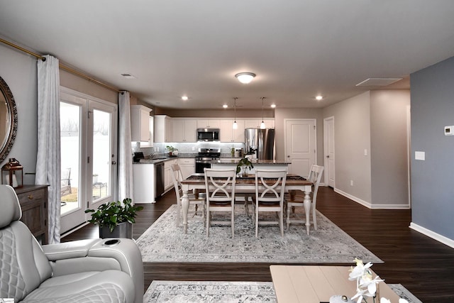 dining area featuring dark hardwood / wood-style flooring and sink